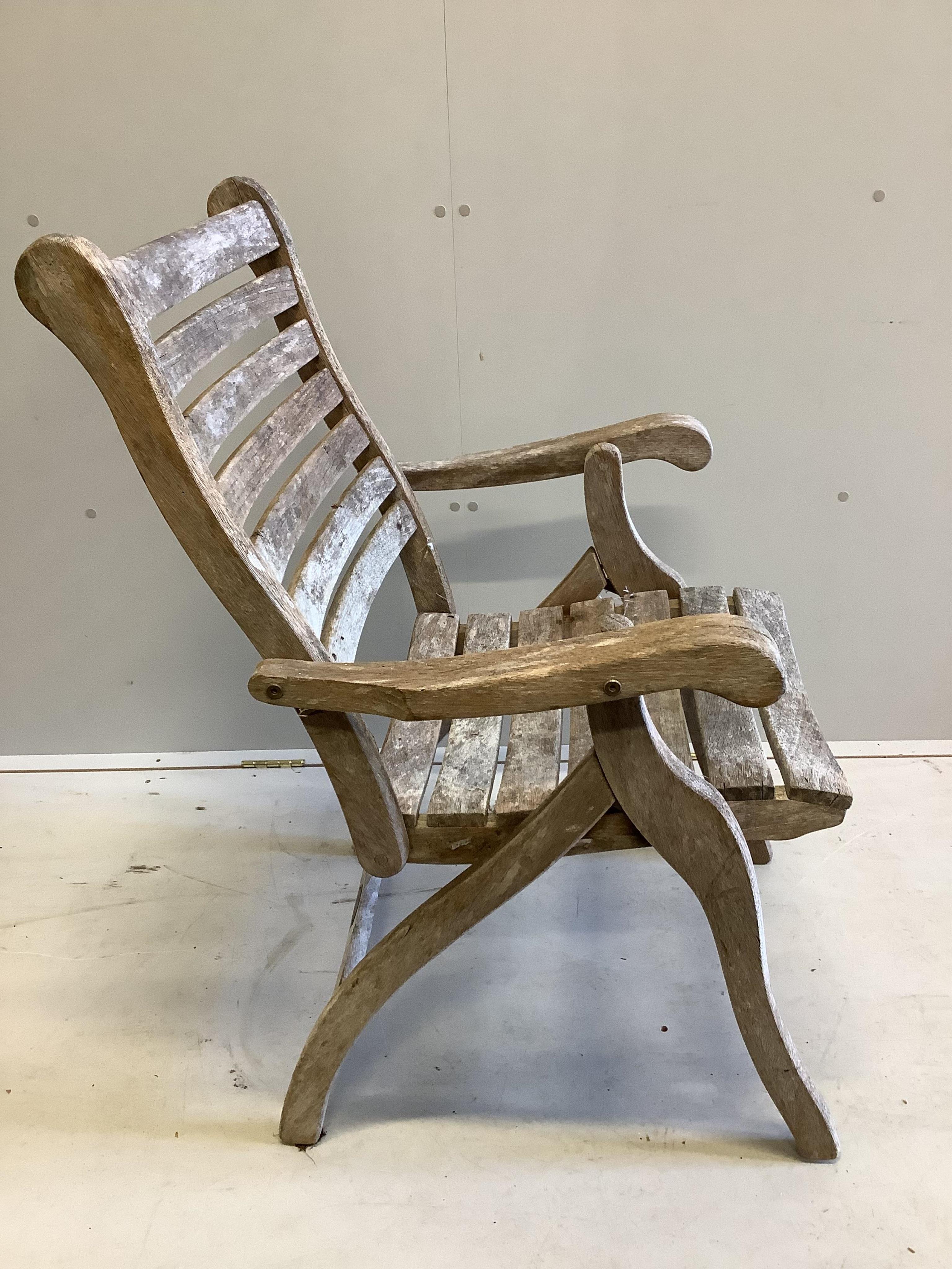 An Alexander Rose circular teak folding garden table with a set of four folding chairs. Condition - table fair, chairs more notably weathered